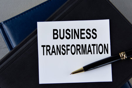 Business transformation- words on white sheet on a black leather book with pen. business conceptの写真素材