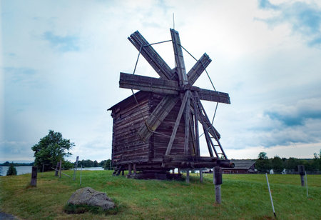 Rural landscape at dawn, area with green fields and an old windmill.の写真素材