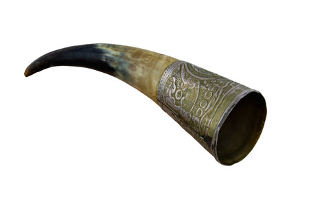 Old drinking horn isolated on white background. Souvenir horn for alcoholic drinks inlaid with metal.の写真素材