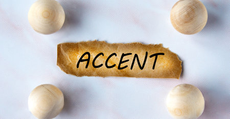 ACCENT - word on a brown torn piece of paper on a light background with balls.の写真素材