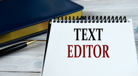 TEXT EDITOR - words in a notebook on the background of a weekly and a pen. info conceptの写真素材
