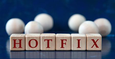 HOTFIX - word on wooden cubes on a blue background with wooden balls. info conceptの写真素材
