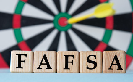 FAFSA - acronym on wooden cubes on dartboard background. business conceptの写真素材