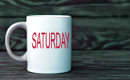 SATURDAY - the word on a white cup on a dark background.の写真素材