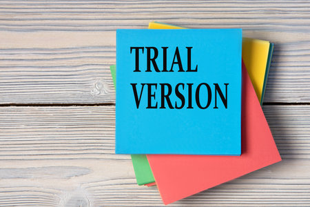 TRIAL VERSION - words on note paper on wooden light background. Info conceptの写真素材