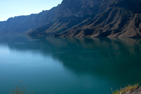 Emerald lake with reflection of mountains on water backgroundの写真素材