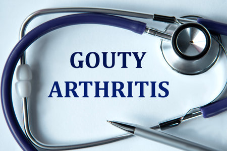GOUTY ARTHRITIS - words on white background with pen and stethoscope. Medical conceptの写真素材
