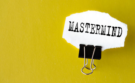 MASTERMIND - the word is printed on a white piece of paper on a yellow background