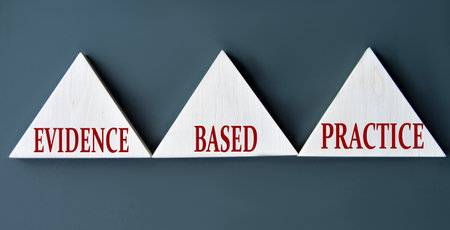 EVIDENCE, BASED, PRACTICE - words on wooden triangles on dark background. Business conceptの写真素材