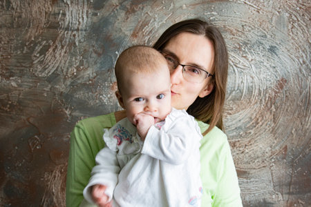 Young woman holding a small child in her arms
