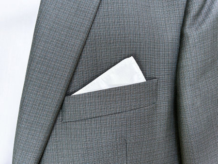 Part of a man's suit, gray jacket on a template, businessman, collar, shirt, white handkerchief, close-upの写真素材