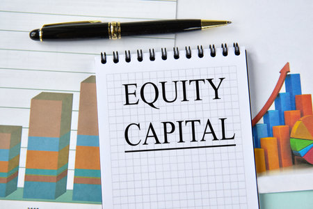 EQUITY CAPITAL - words in notebook on the background of a chart and a pen. Business conceptの写真素材