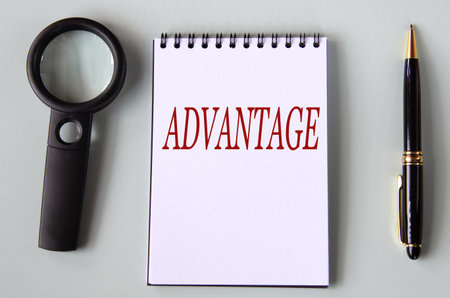 ADVANTAGE - the word are in a black notebook with a magnifying glass and pen in the background.の写真素材
