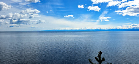 clouds and rising sun rays over lake Baikal