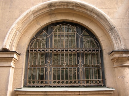 Openwork metal grille on the windowの写真素材
