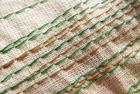 Embroidery stitches on the fabric. Background. Macro. Manual work.の写真素材