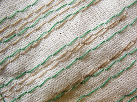 Embroidery stitches on the fabric. Background. Macro. Manual work.