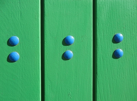 A fragment of a wooden door with boltsの写真素材
