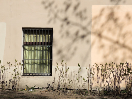 Wall with a window, sunny spring dayの写真素材