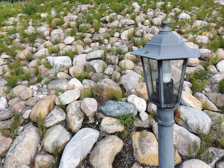 Garden lantern on background of decorative rock embankmentの写真素材