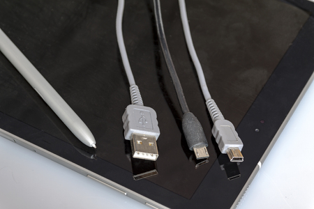 USB cables lie on the Tabletの写真素材