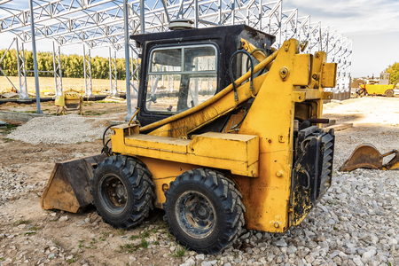 Mini bulldozer in action on a construction site.の写真素材