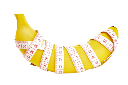 Banana wrapped with measuring tapeの写真素材