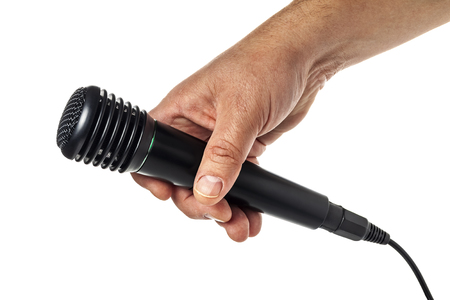 Hand holding a microphone interview conducting a business isolated on white backgroundの写真素材