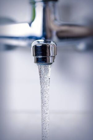water flows from the kitchen tap, close-upの写真素材