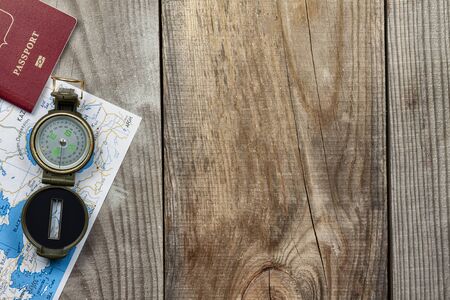 Travel Planning Concept. Compass, passport, map lie on a wooden background