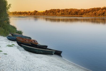 Evening, boats on the river bank