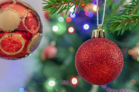 New Year's toys on the background of the Christmas tree and garlandの写真素材