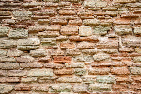 Background. Ancient masonry of a brick wall.の写真素材