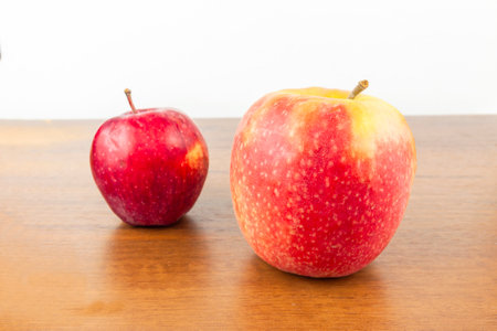 An apple with a stack of paper is on the tableの写真素材