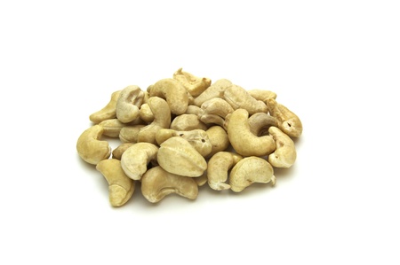 a pile of raw cashew nuts on white backgroundの写真素材