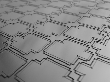 a panel of etched metal rf shields screens for electronicsの写真素材