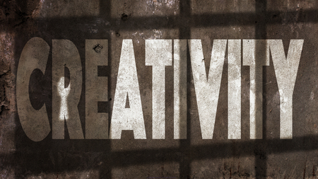 Creativity Written On A Wall With Jail Bars Shadowの写真素材