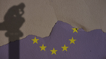 Thinker Shadow on Europe Flag and Grey Plaster Concrete Wallの写真素材