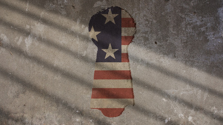 US Flag and Keyhole on Concrete With Shadow Gate