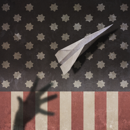 US Flag Paper Airplane and Shadow Handの写真素材