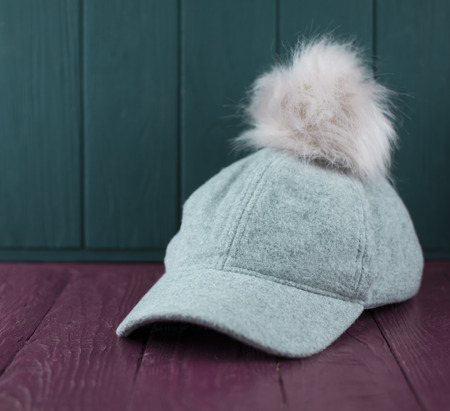 Gray baseball cap from a coat fabric with a pink pompon