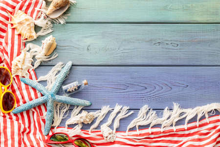 summer background: photo frame, starfish, seashells on a blue wooden backgroundの写真素材
