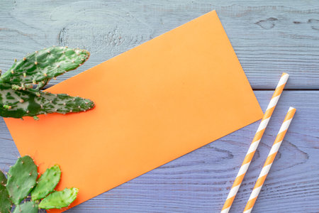 summer background: fringed pareos, seashells, sun goggles, starfish on a blue wooden backgroundの写真素材