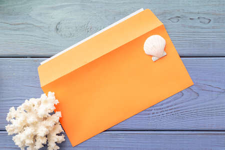 summer background: fringed pareos, seashells, sun goggles, starfish on a blue wooden backgroundの写真素材