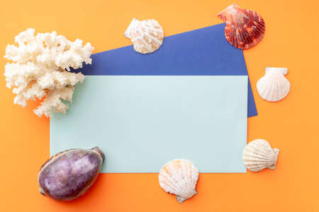 summer background: colored envelopes with seashellsの写真素材