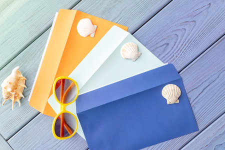 summer background: colored envelopes with seashellsの写真素材