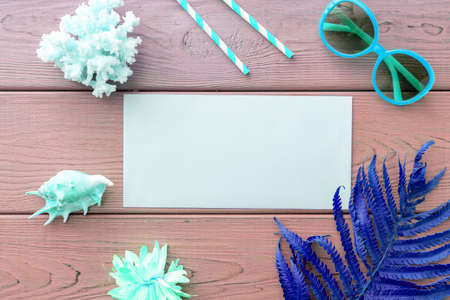 background image with summer vacation concept during quarantine: medical mask, seashells on pink backgroundの写真素材