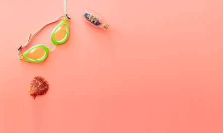 background image with summer vacation concept during quarantine: medical mask, seashells on pink backgroundの写真素材