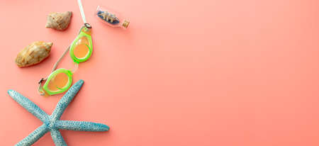 summer background of sandals, coral, starfish on pink backgroundの写真素材