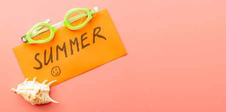 summer background of sandals, coral, starfish on pink backgroundの写真素材